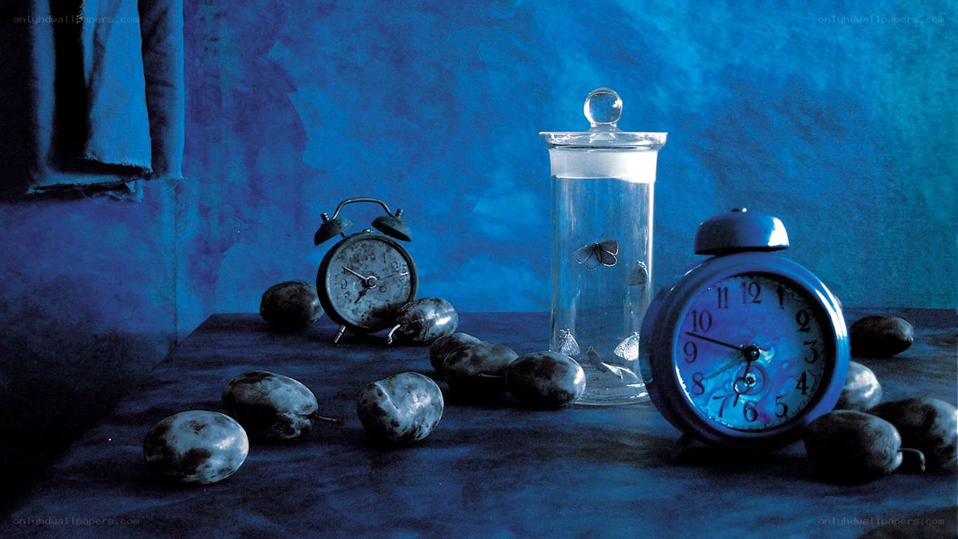 Blue-lit still life with clocks