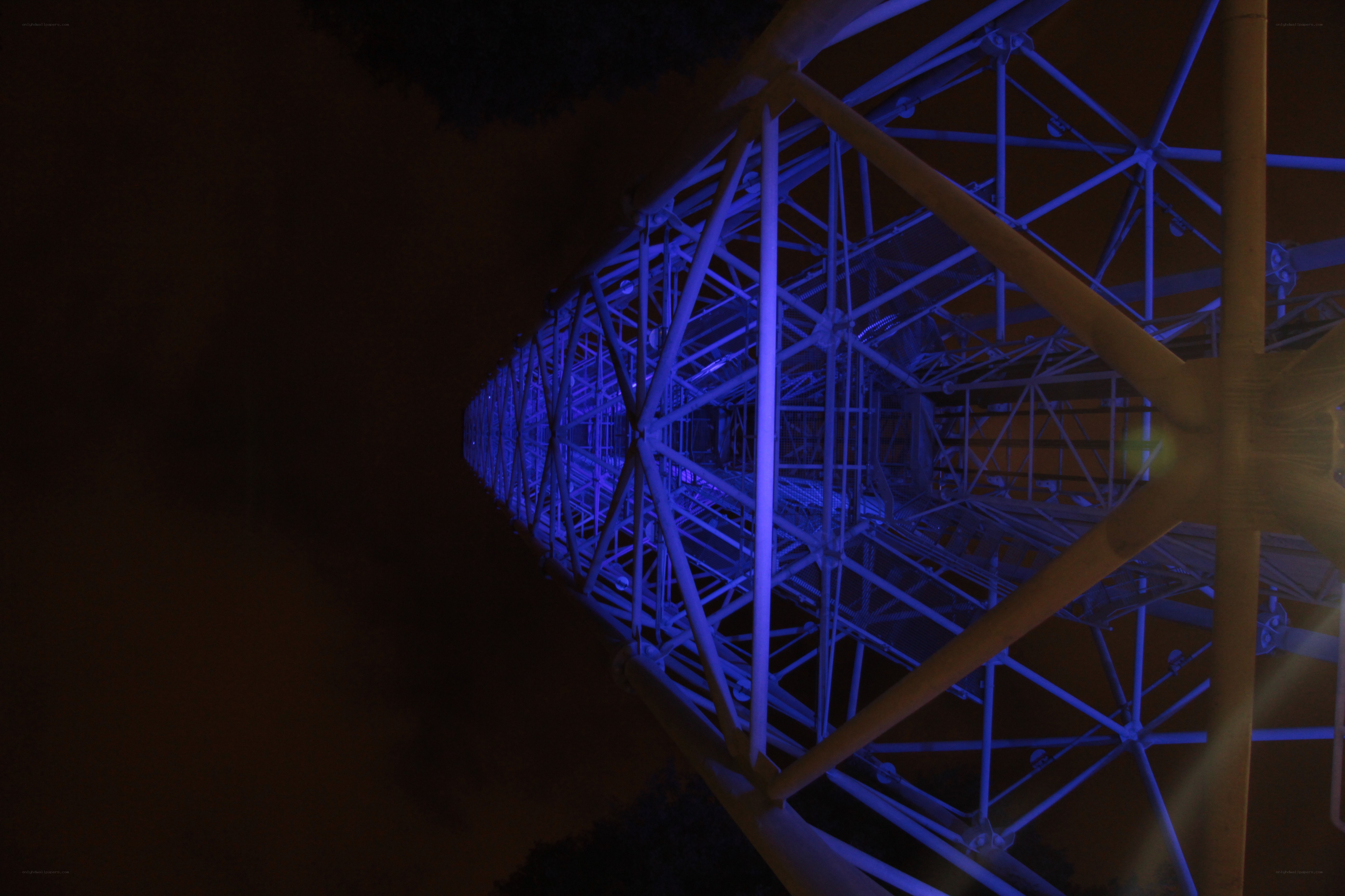 blue-lit tower structure at night