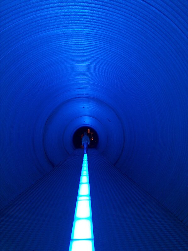 blue-lit tunnel walkway