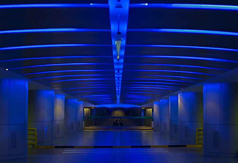Blue-lit underground corridor