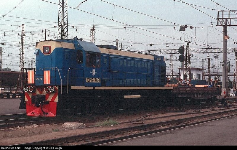 Blue locomotive at a rail yard