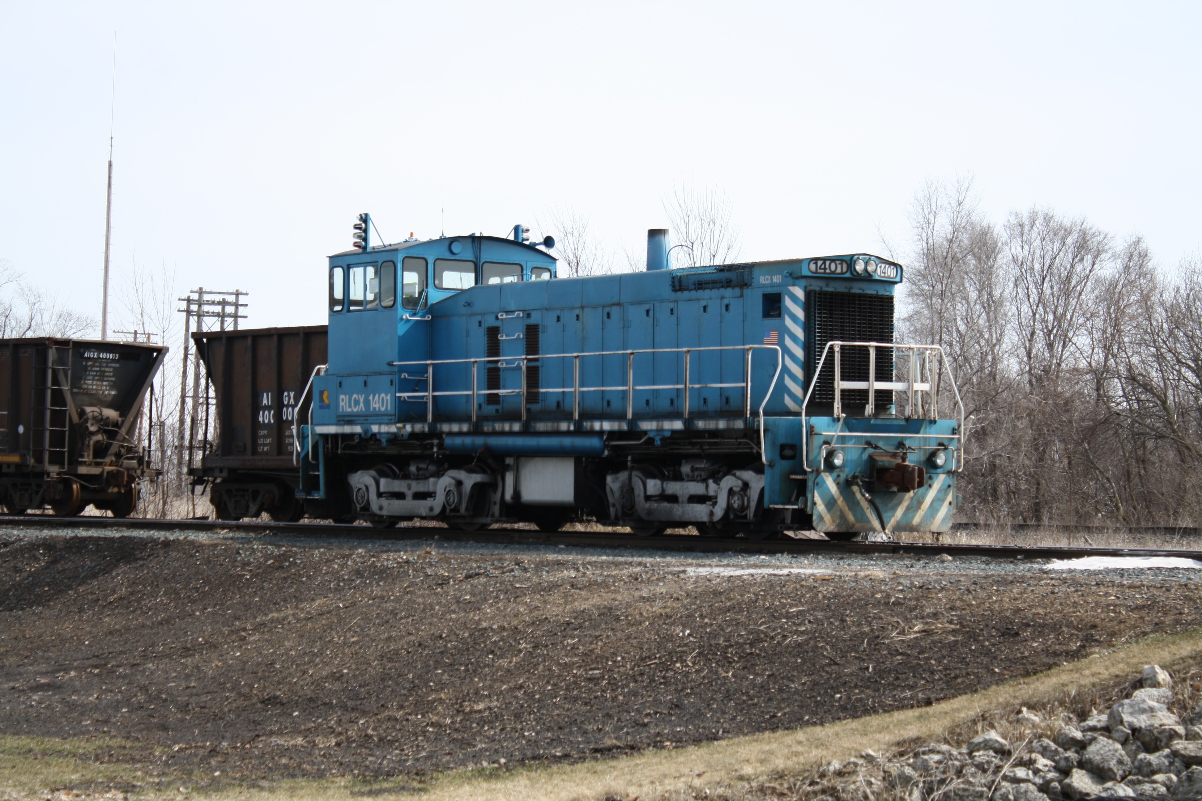 Blue locomotive on tracks