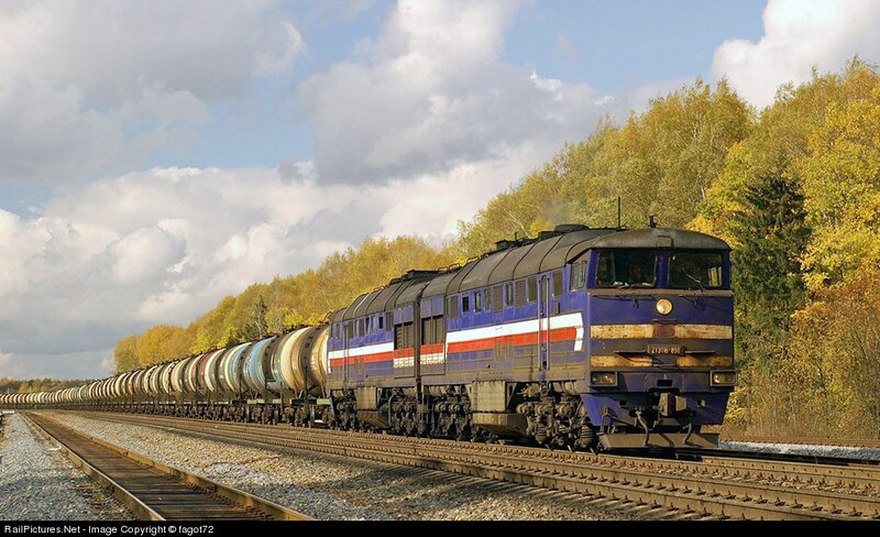 Blue locomotive pulling tank cars