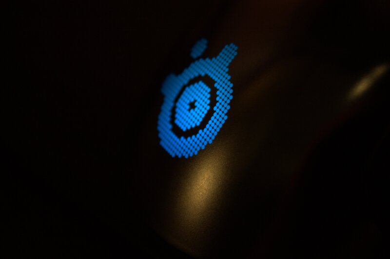 blue logo on dark surface