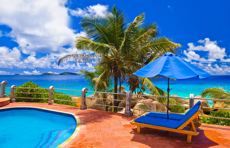 Blue Lounge Chair by Pool — Serene, Afternoon, Photograph, Umbrella