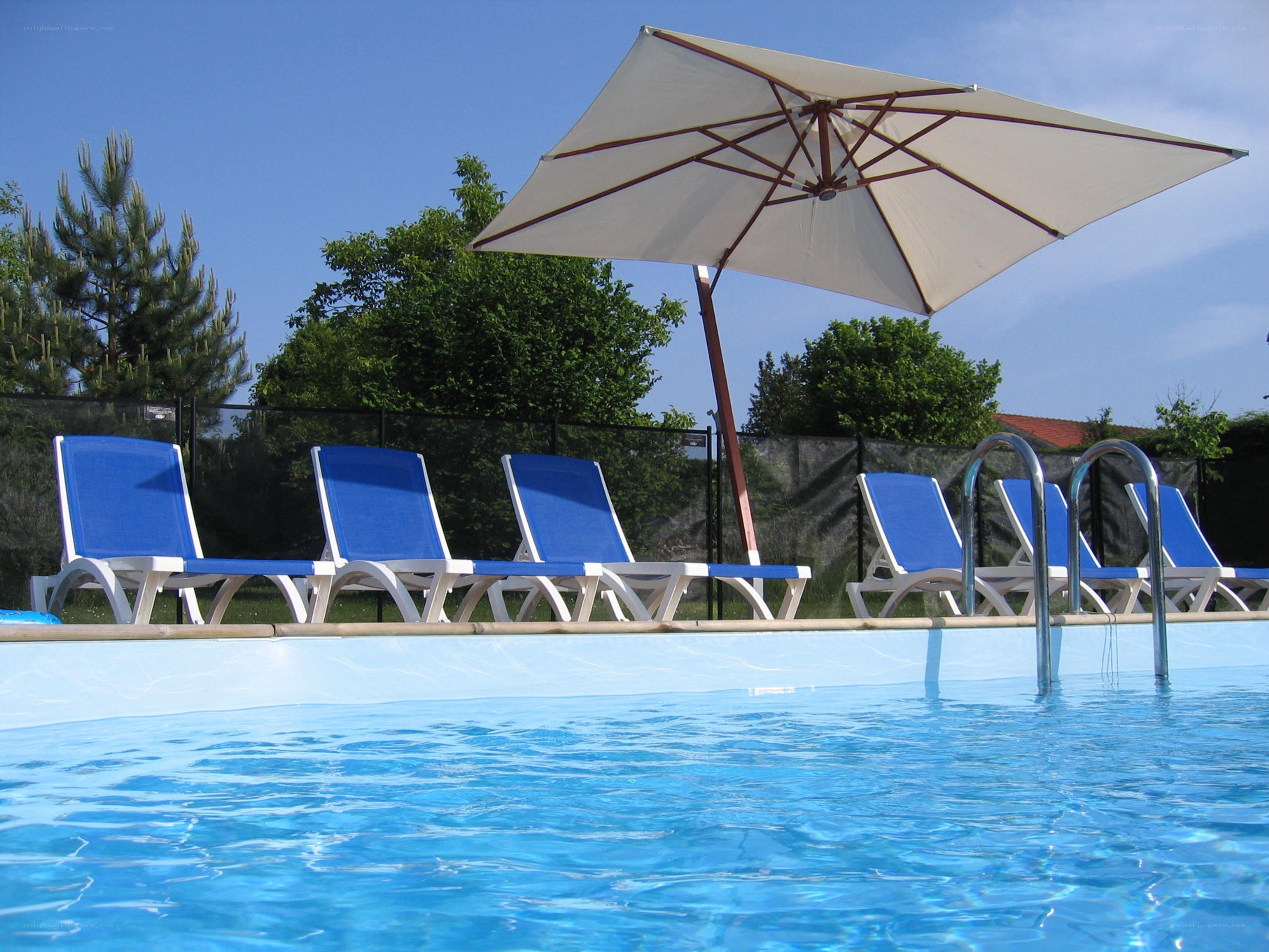 Blue lounge chairs by pool