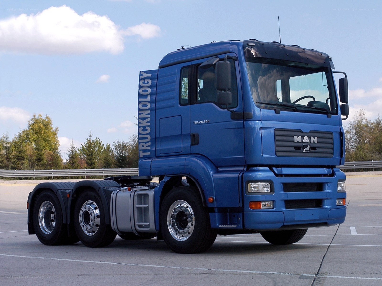 Blue MAN truck on pavement