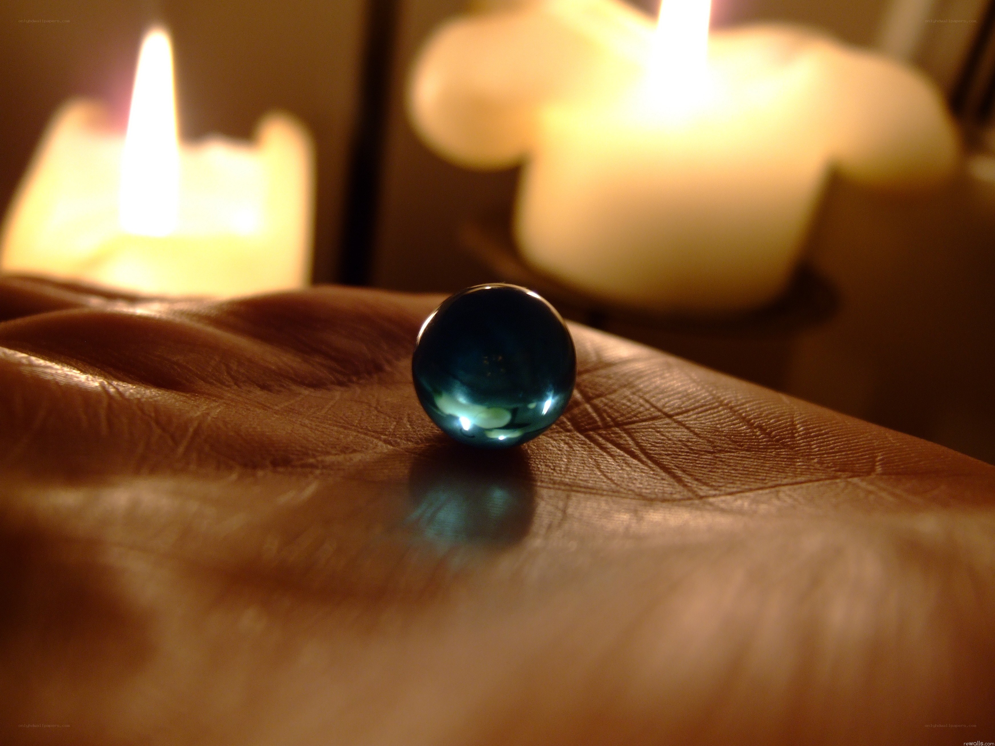 Blue marble on a hand