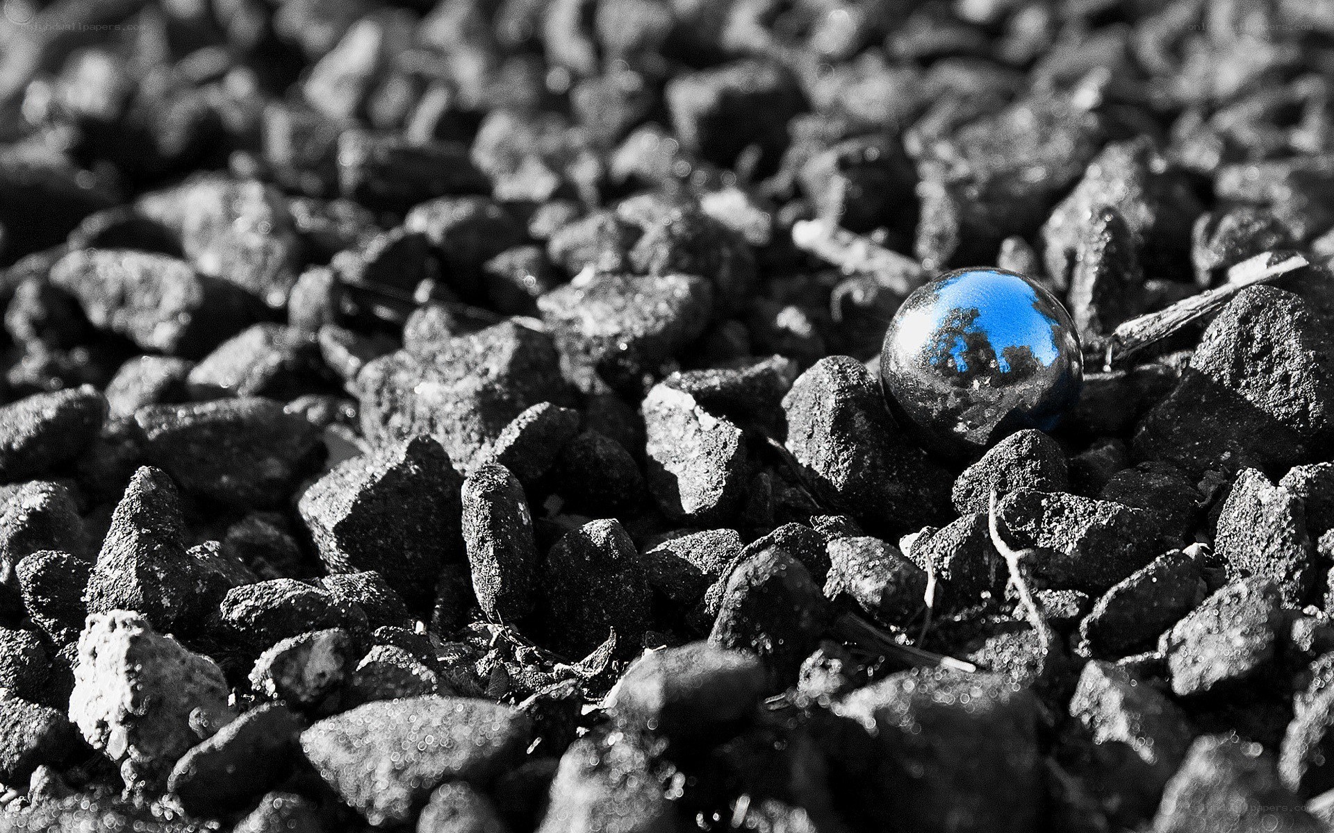 Blue marble on gravel