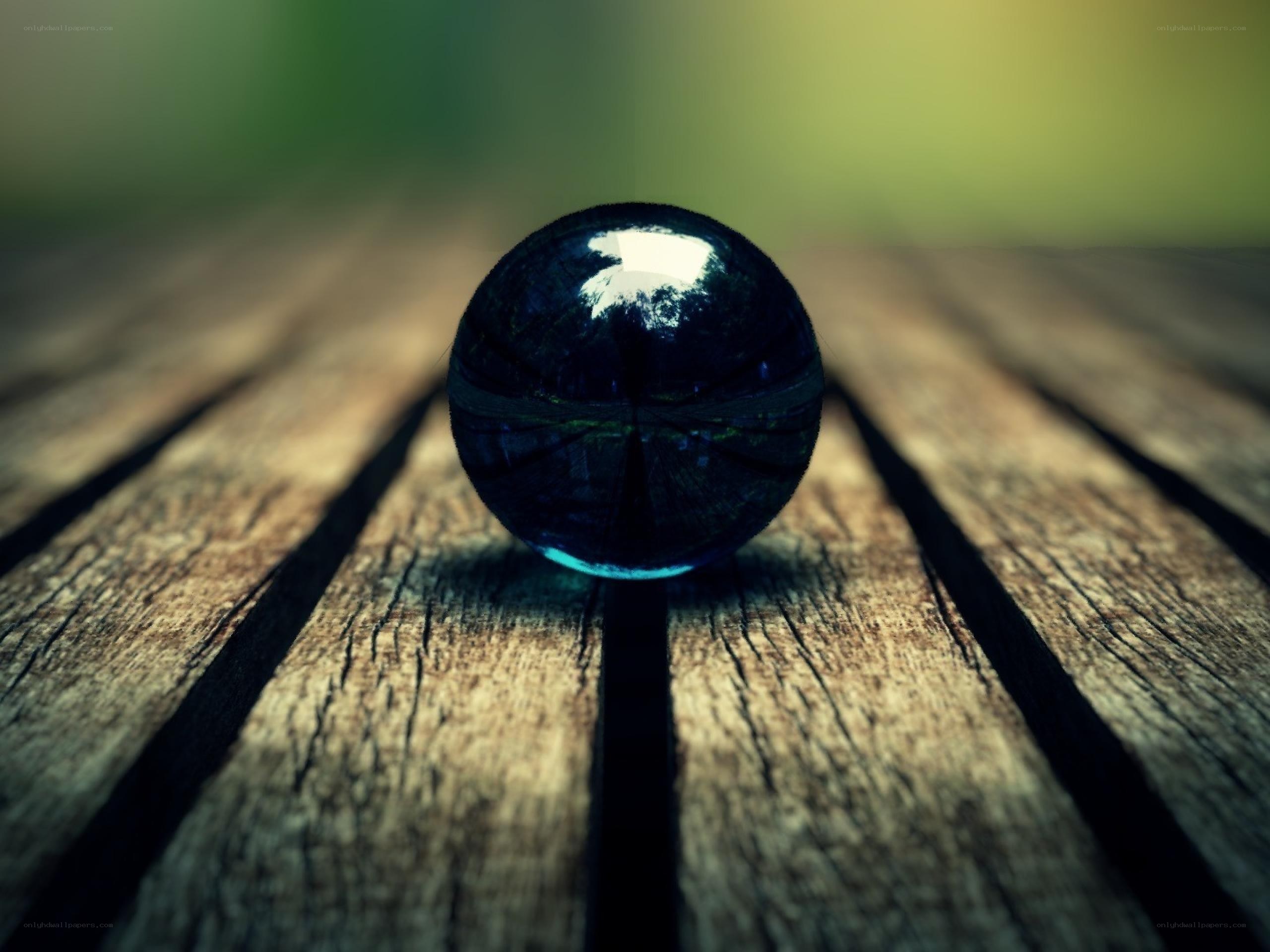 Blue marble on wooden surface