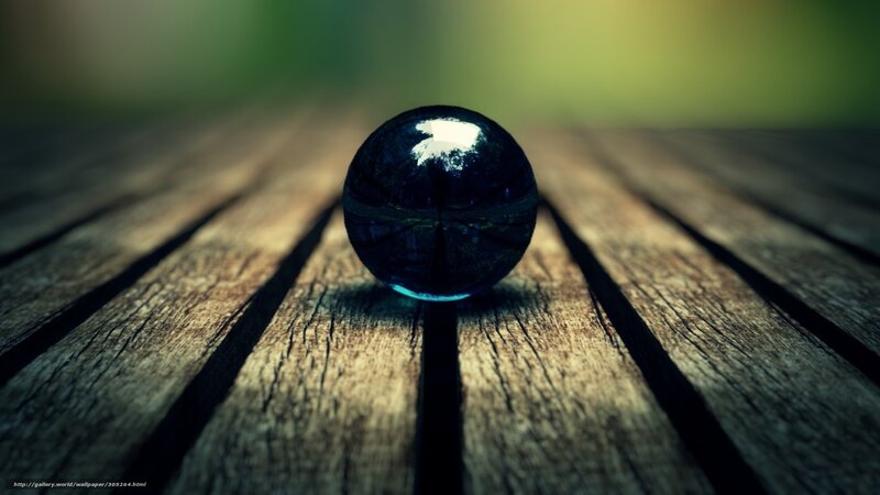 Blue marble on wooden surface