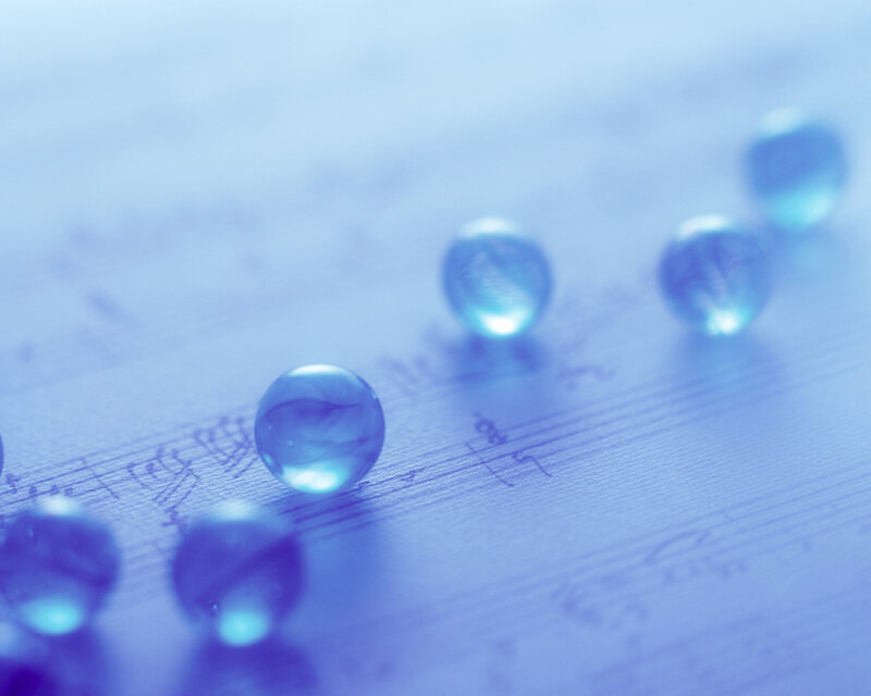 Blue Marbles on Sheet Music — Serene