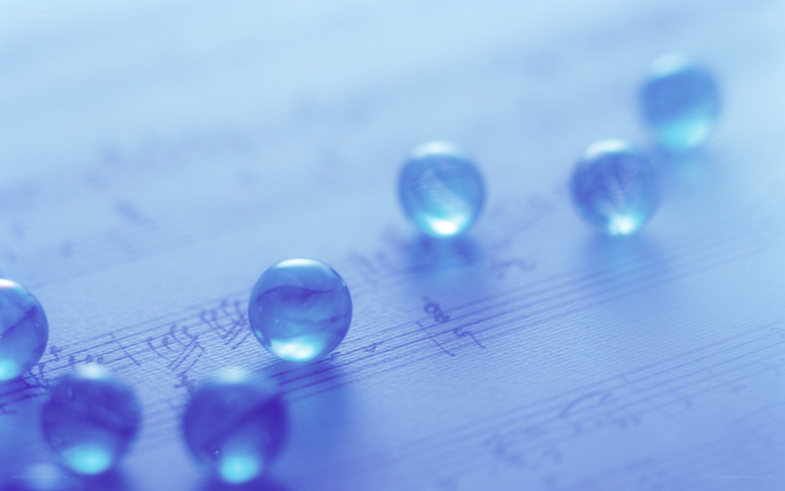 Blue marbles on sheet music