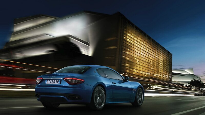 Blue Maserati driving at night