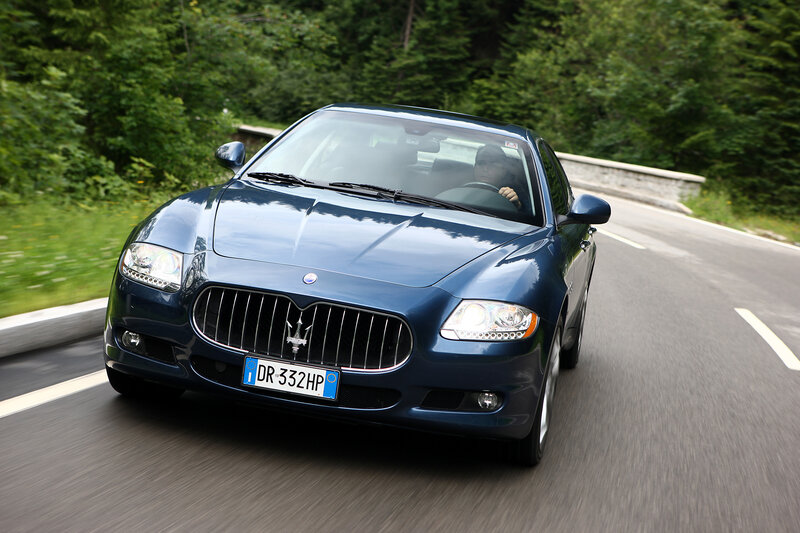 blue maserati driving on road
