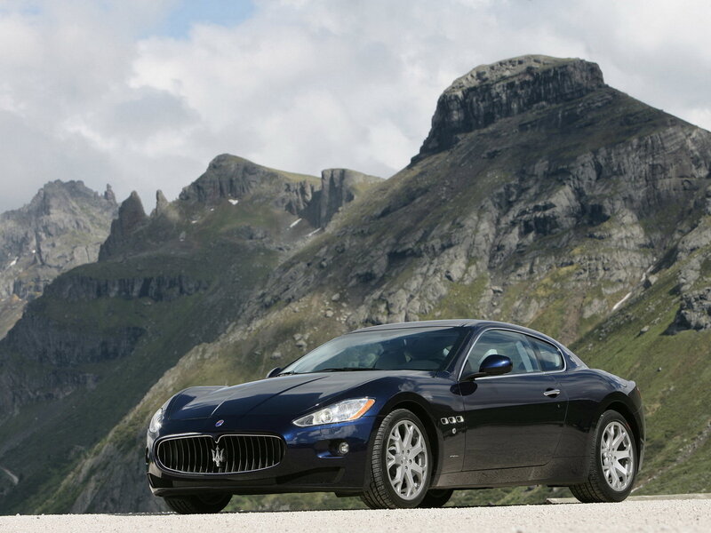 Blue Maserati in mountain setting