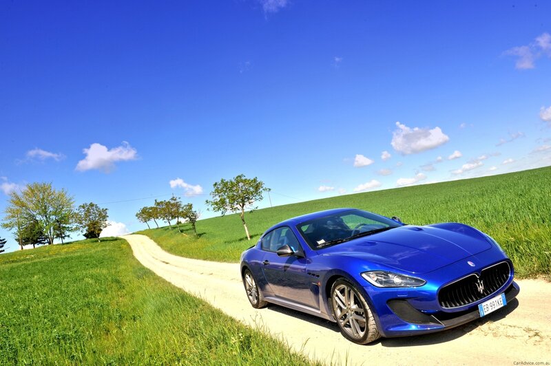 Blue Maserati on a country road