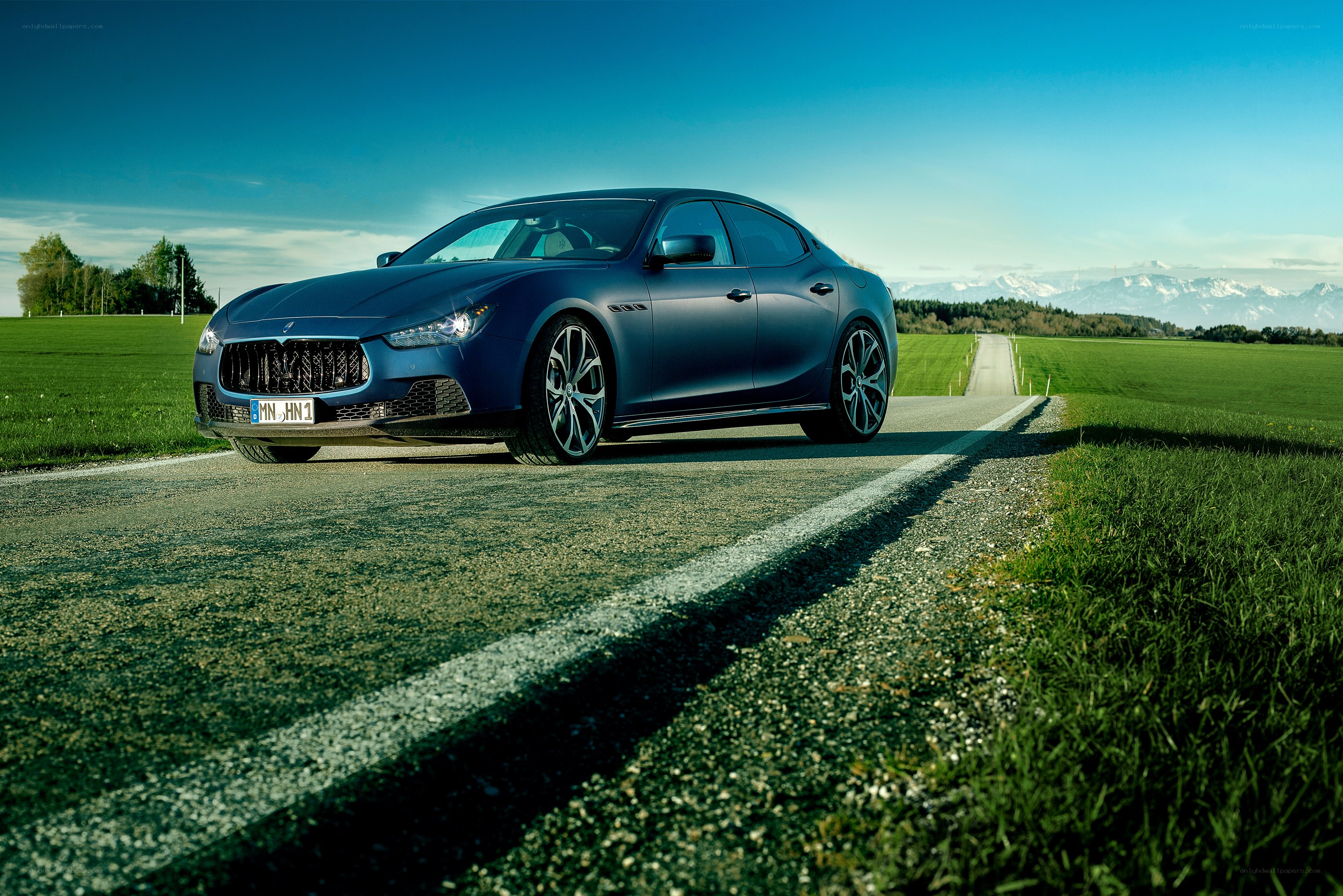 Blue Maserati on a country road