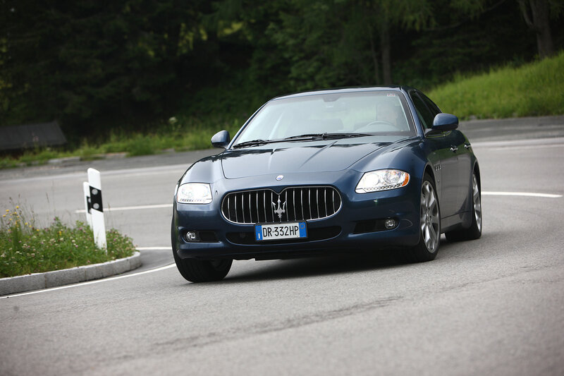 Blue Maserati on a winding road