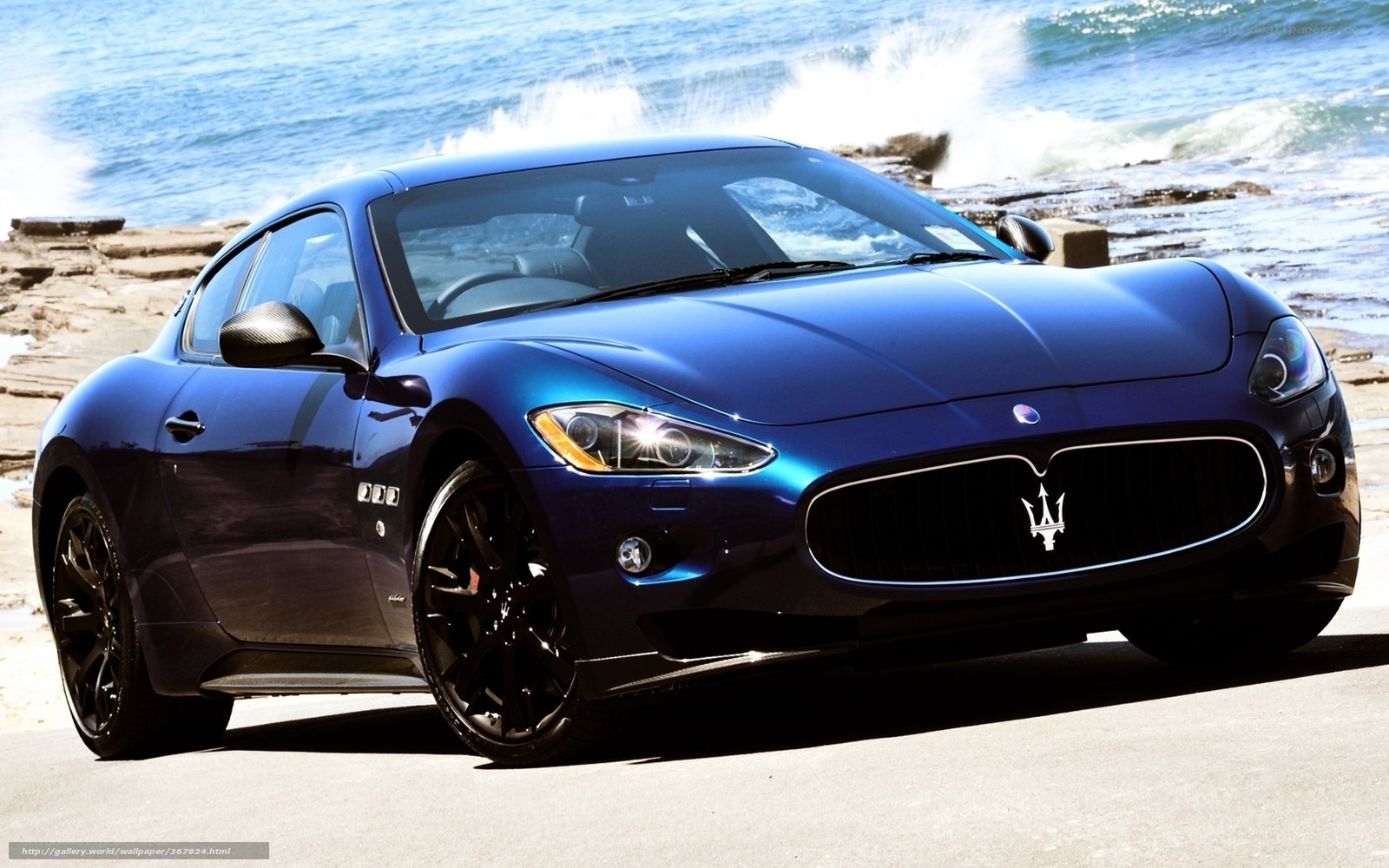 Blue Maserati on beach