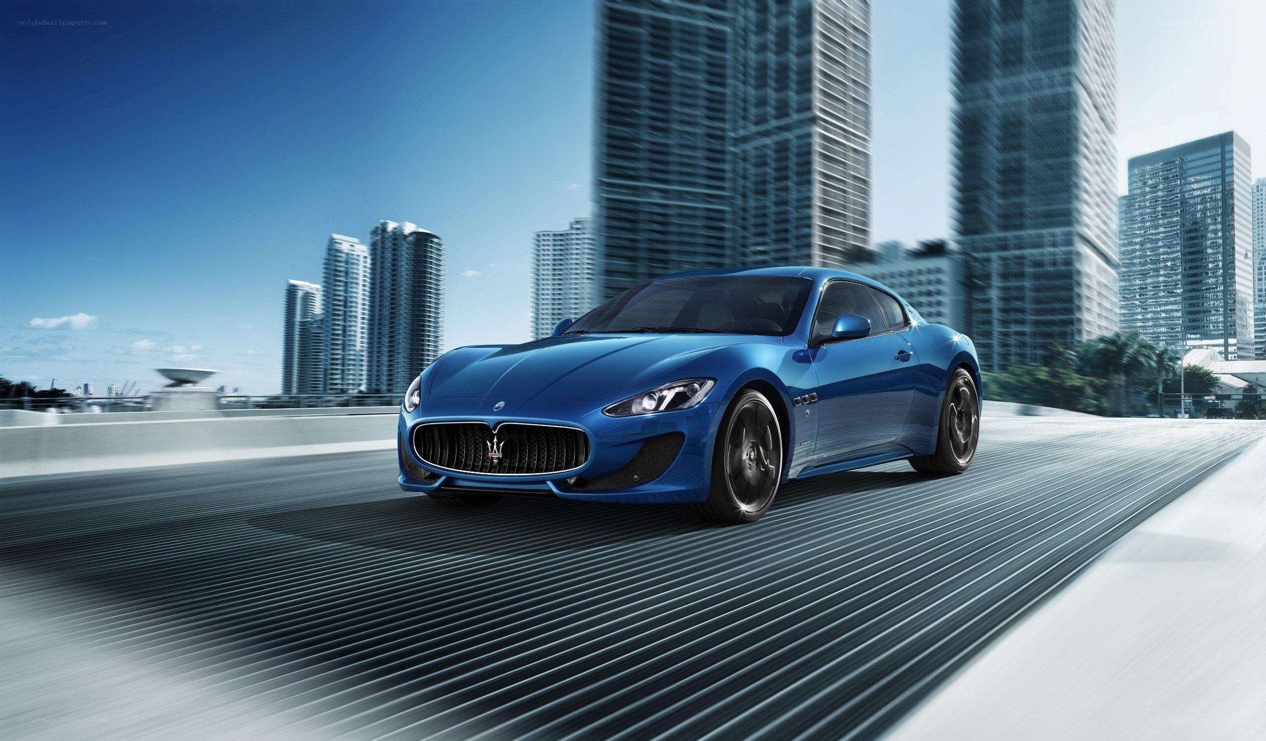 Blue Maserati on city road