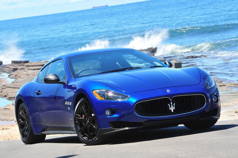 Blue Maserati on coastal road