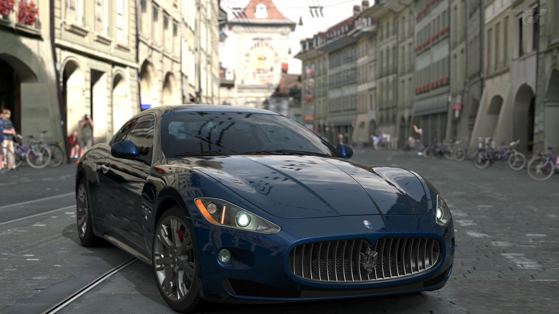Blue Maserati on cobblestone street