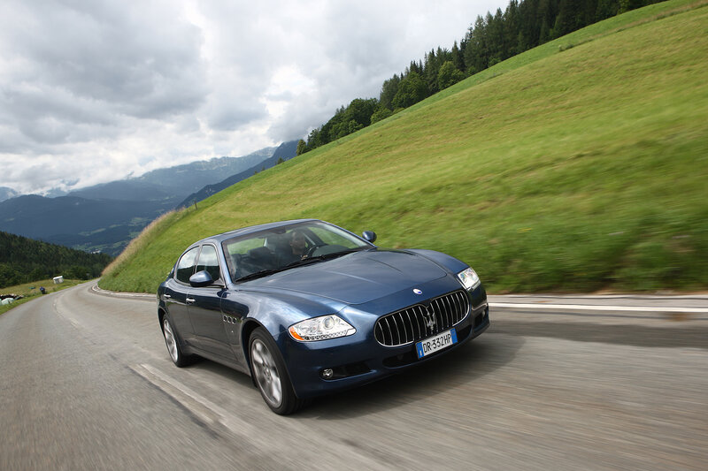 Blue Maserati on mountain road