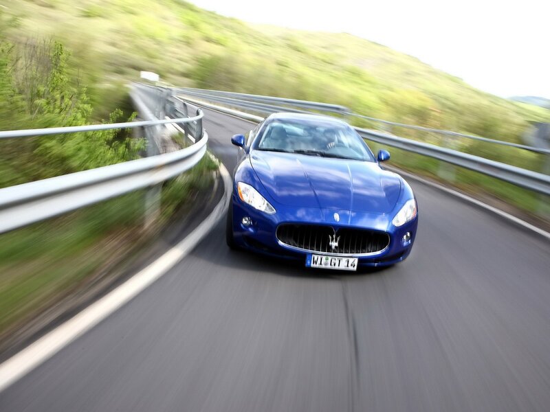 Blue Maserati on winding road