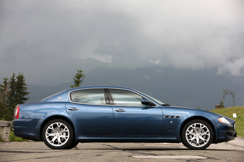 Blue Maserati sedan on mountain road