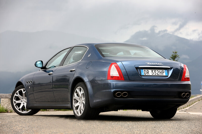 Blue Maserati sedan on mountain road
