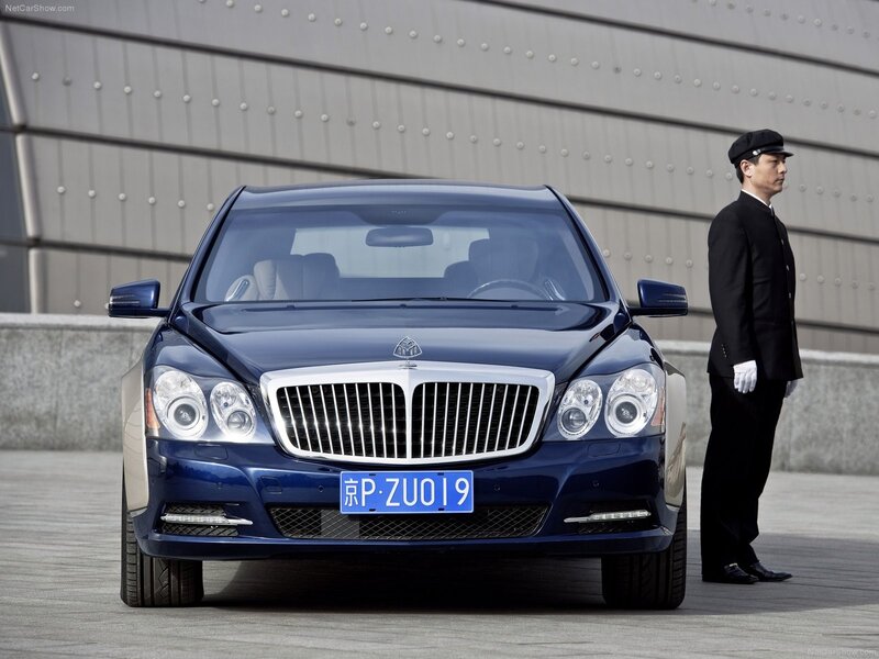 Blue Maybach sedan with doorman