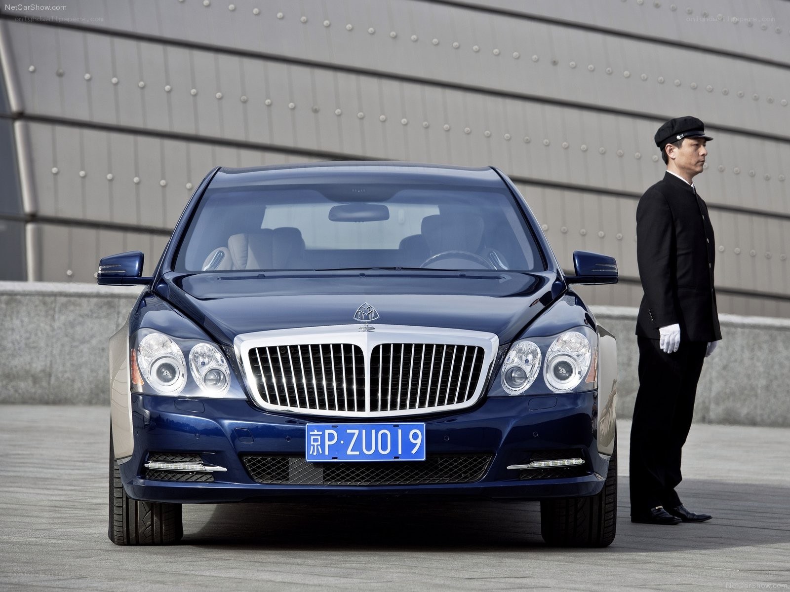 Blue Maybach sedan with doorman
