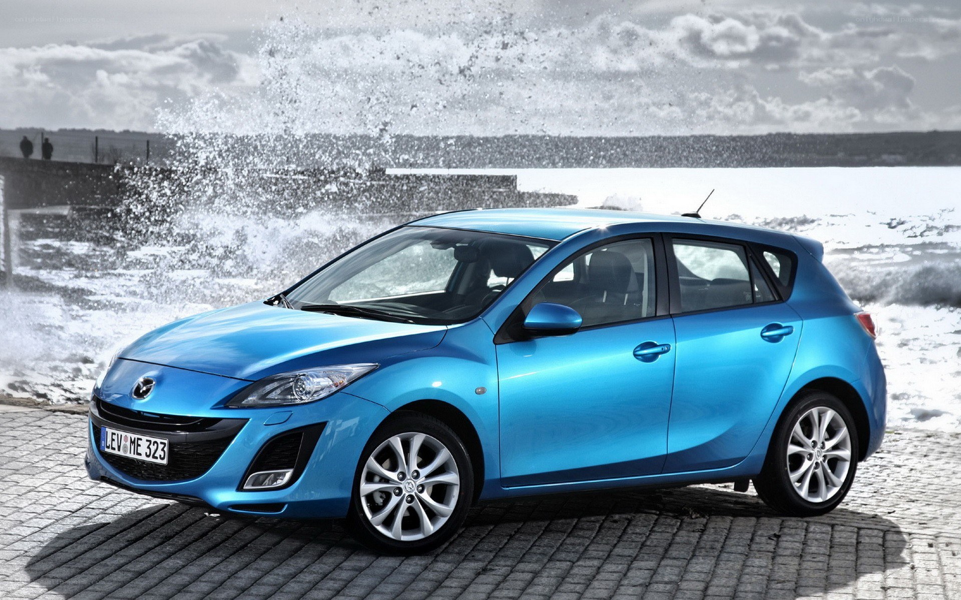 Blue Mazda 3 by the sea
