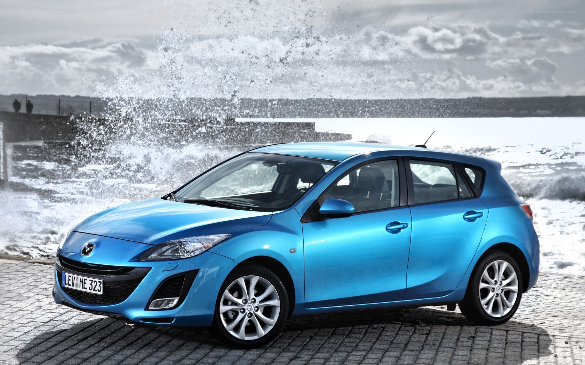 Blue Mazda 3 by the sea