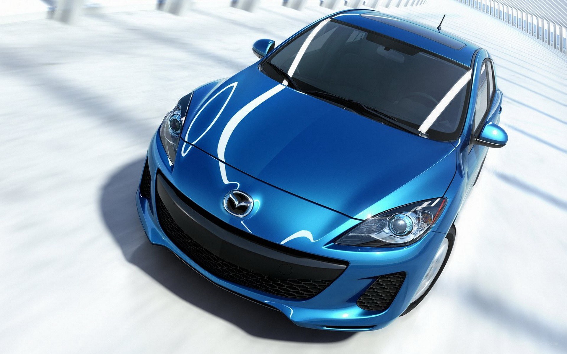 blue mazda 3 in motion