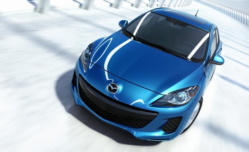 Blue Mazda 3 in motion