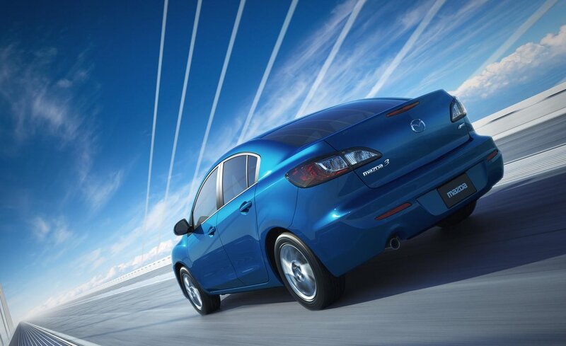 Blue Mazda 3 in motion