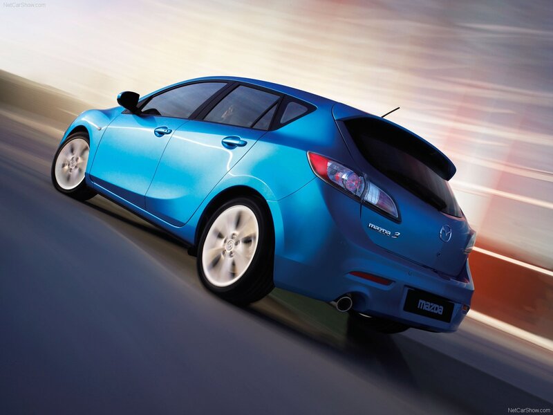 Blue Mazda 3 in motion