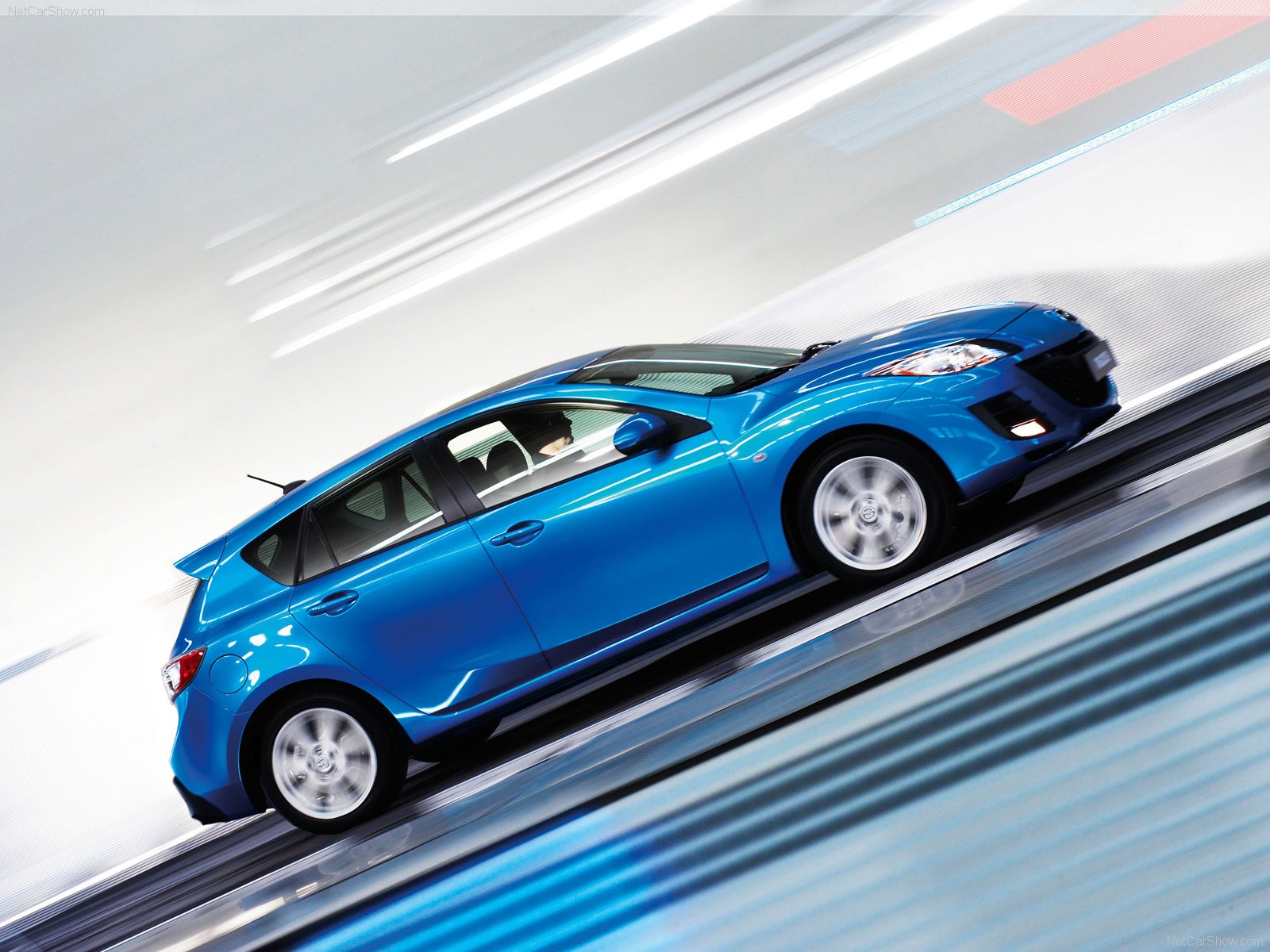 blue mazda 3 in motion
