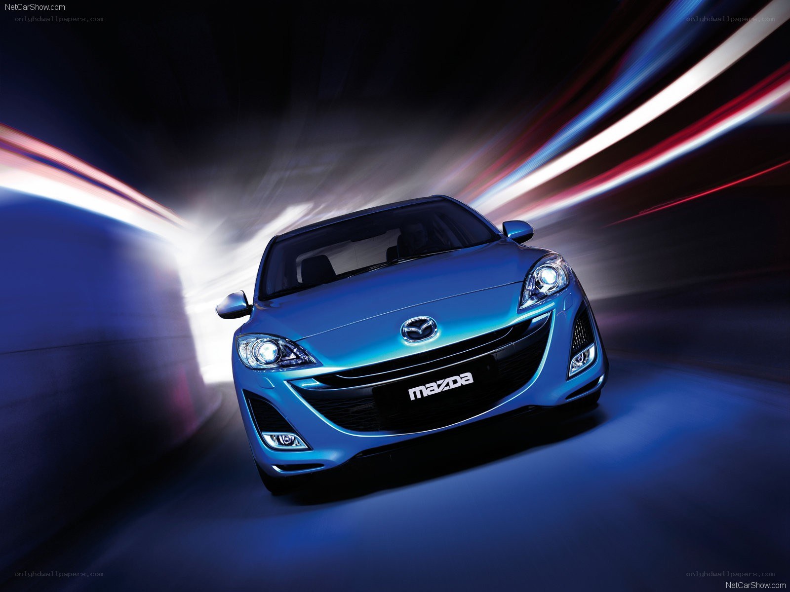 Blue Mazda 3 in motion