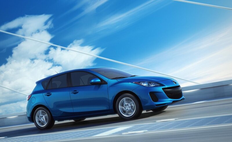 Blue Mazda 3 on a bridge