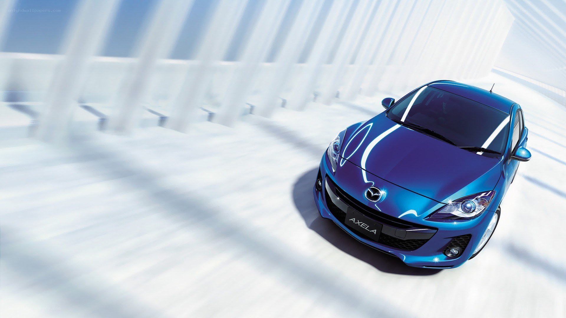 Blue Mazda Axela in motion