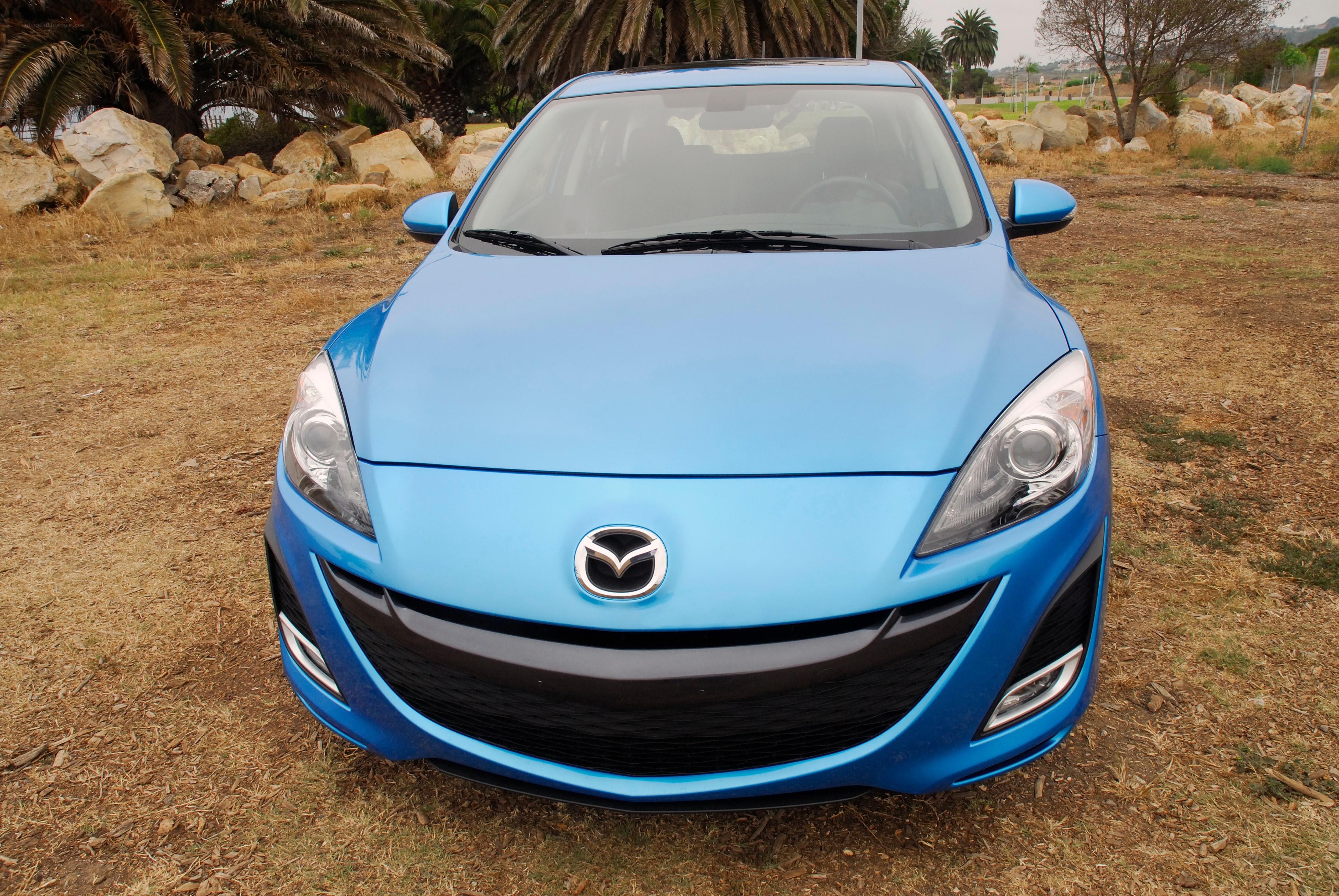blue mazda car on grass