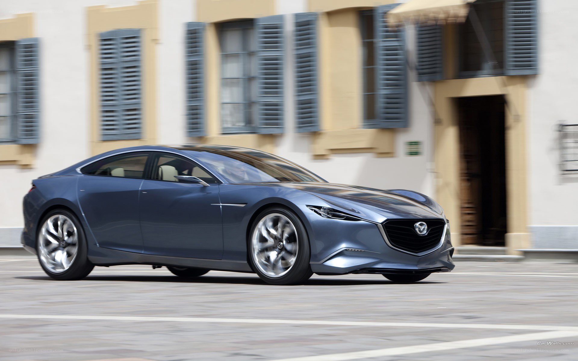 Blue Mazda concept car in motion