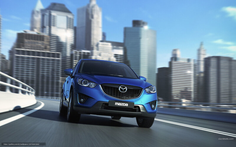 Blue Mazda CX-5 on city bridge