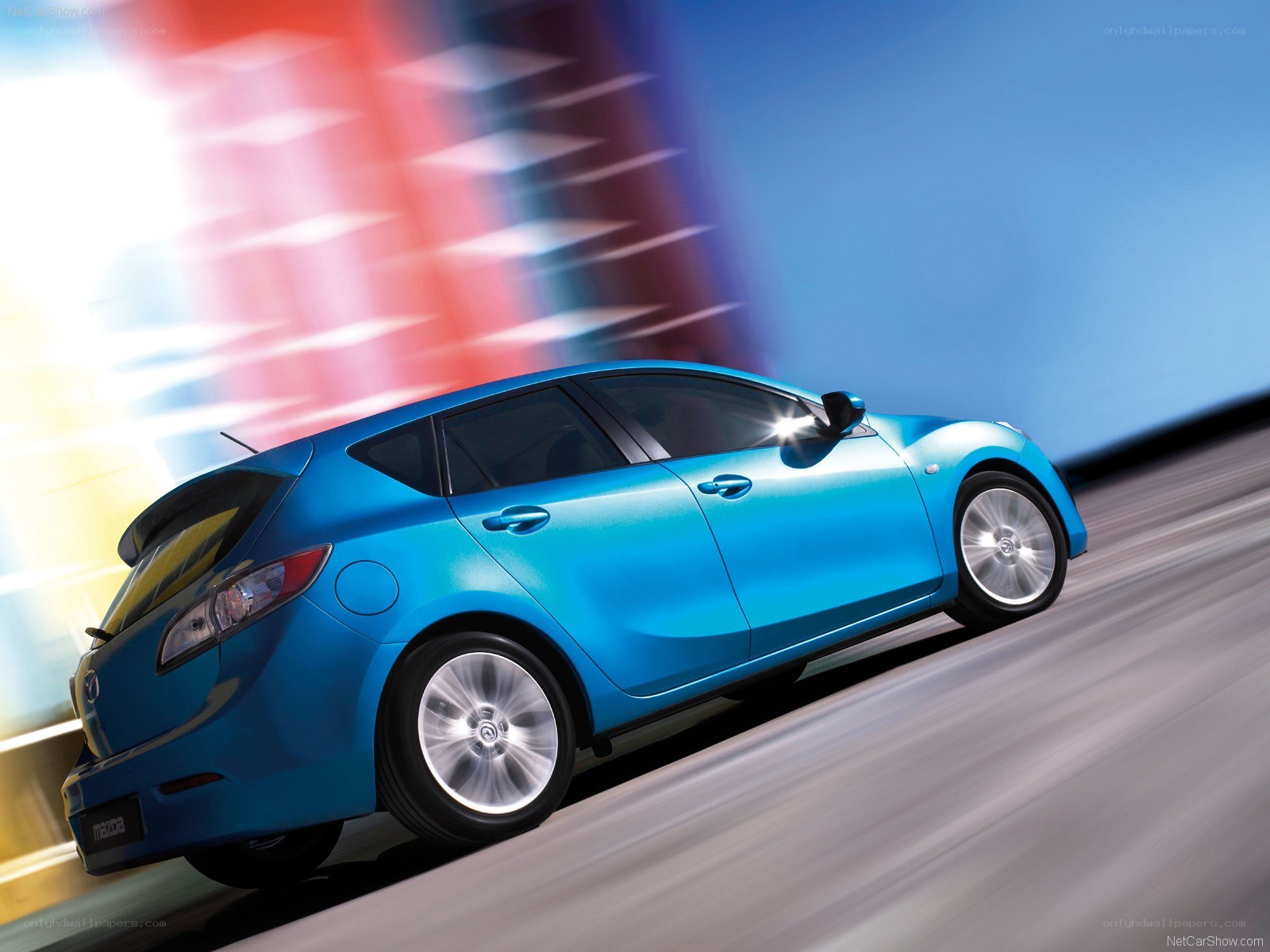 blue mazda hatchback in motion