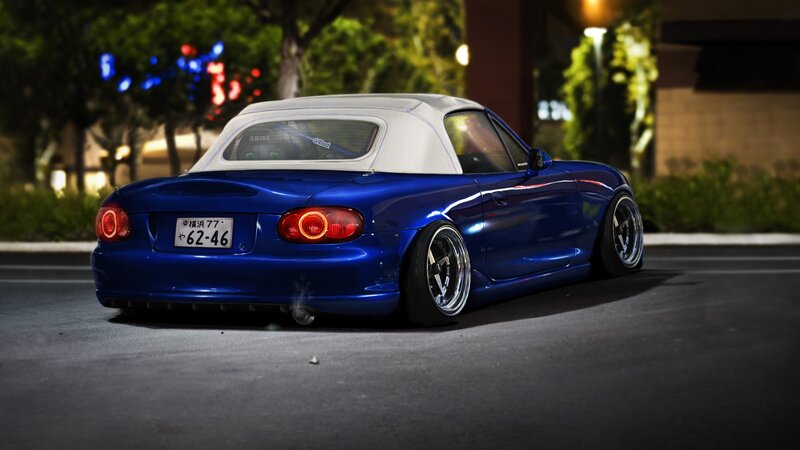 blue mazda miata at night