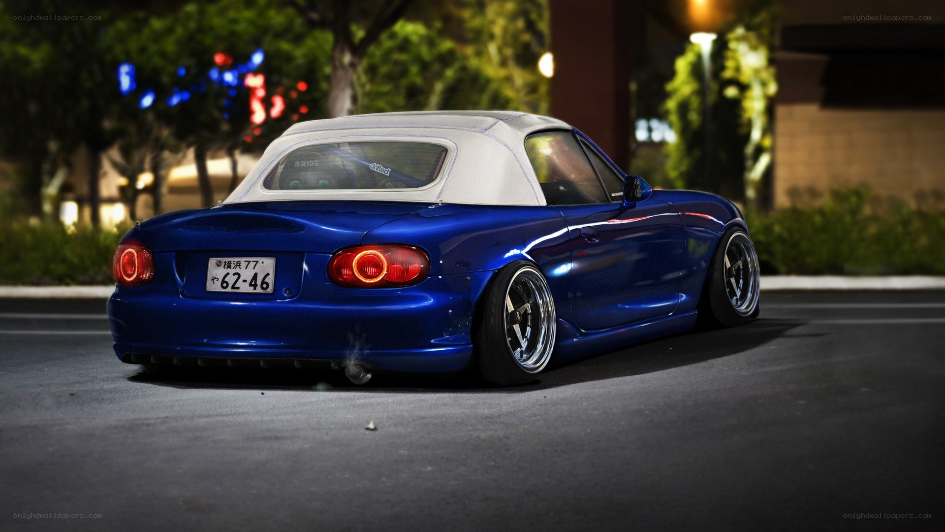 blue mazda miata at night