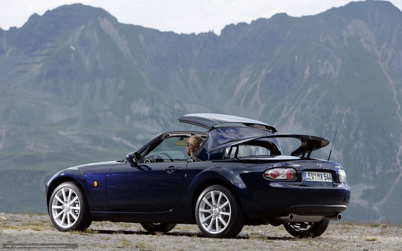Blue Mazda MX-5 in mountain landscape